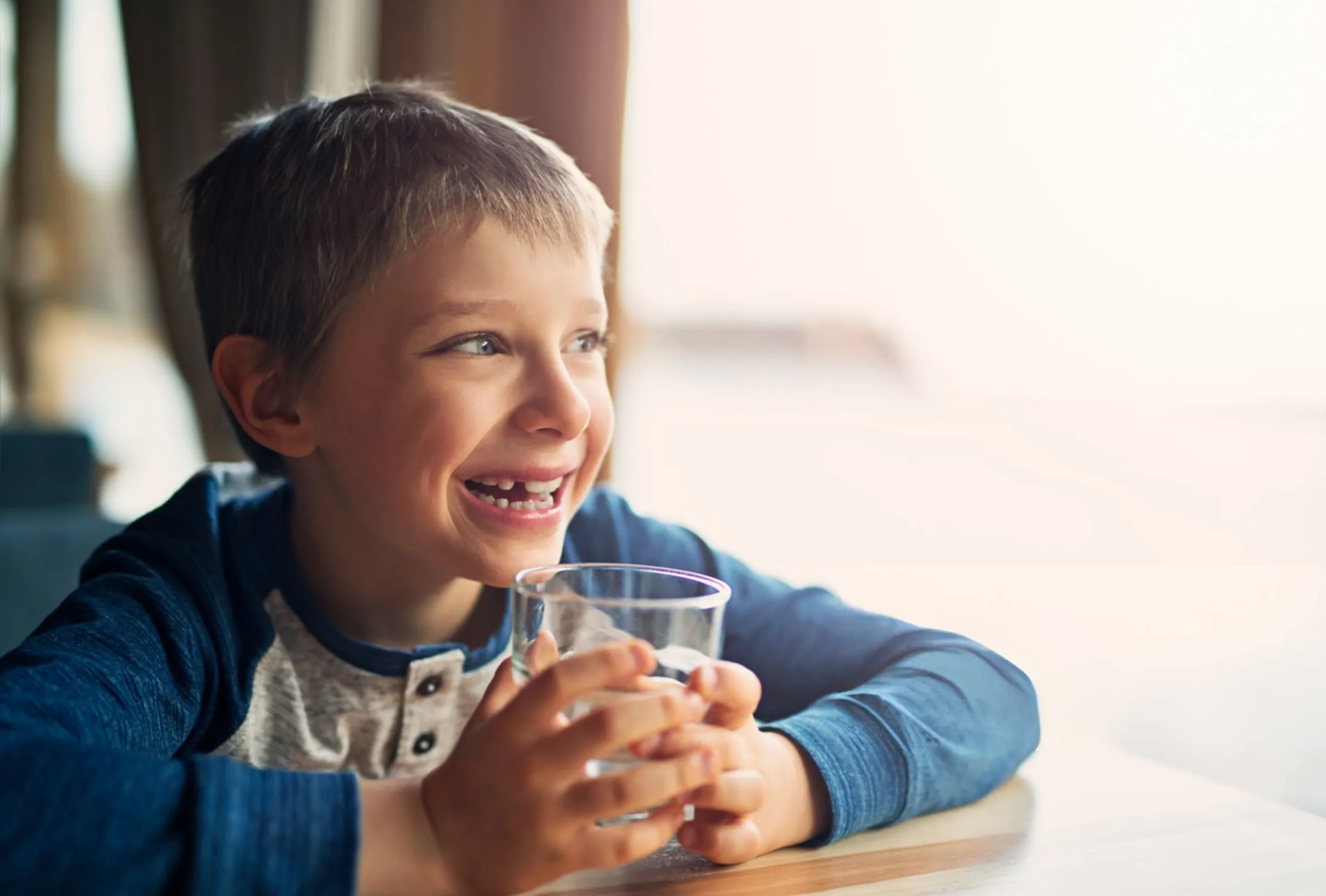 Child drinking water from a glass